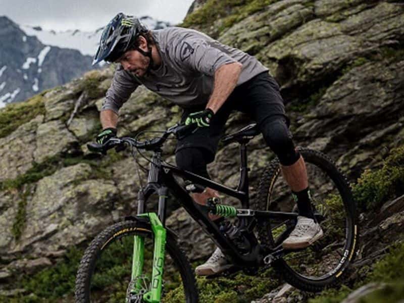 Rider descending a rocky alpine slope on Pirelli Scorpion gravity mountain bike tyres