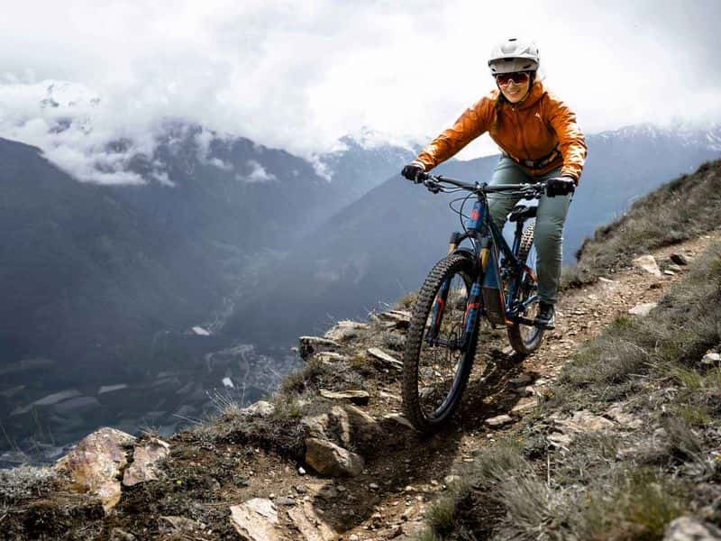 Rider on a Fazua-powered e-mountain bike descending a rocky alpine trail