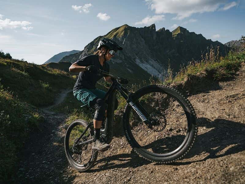 Rider climbing a rocky alpine trail on an e-MTB, SRAM Eagle Transmission campaign photo