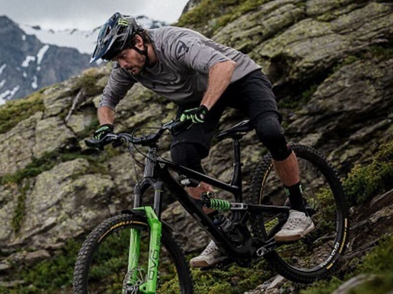 Rider descending a rocky alpine slope on Pirelli Scorpion gravity mountain bike tyres