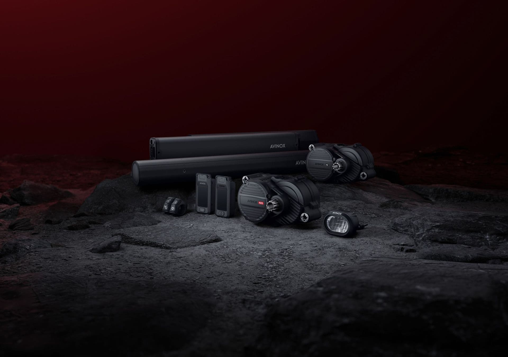 Avinox M2 and M2S drive units with batteries and displays on a rock