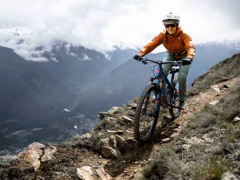 Rider on a Fazua-powered e-mountain bike descending a rocky alpine trail