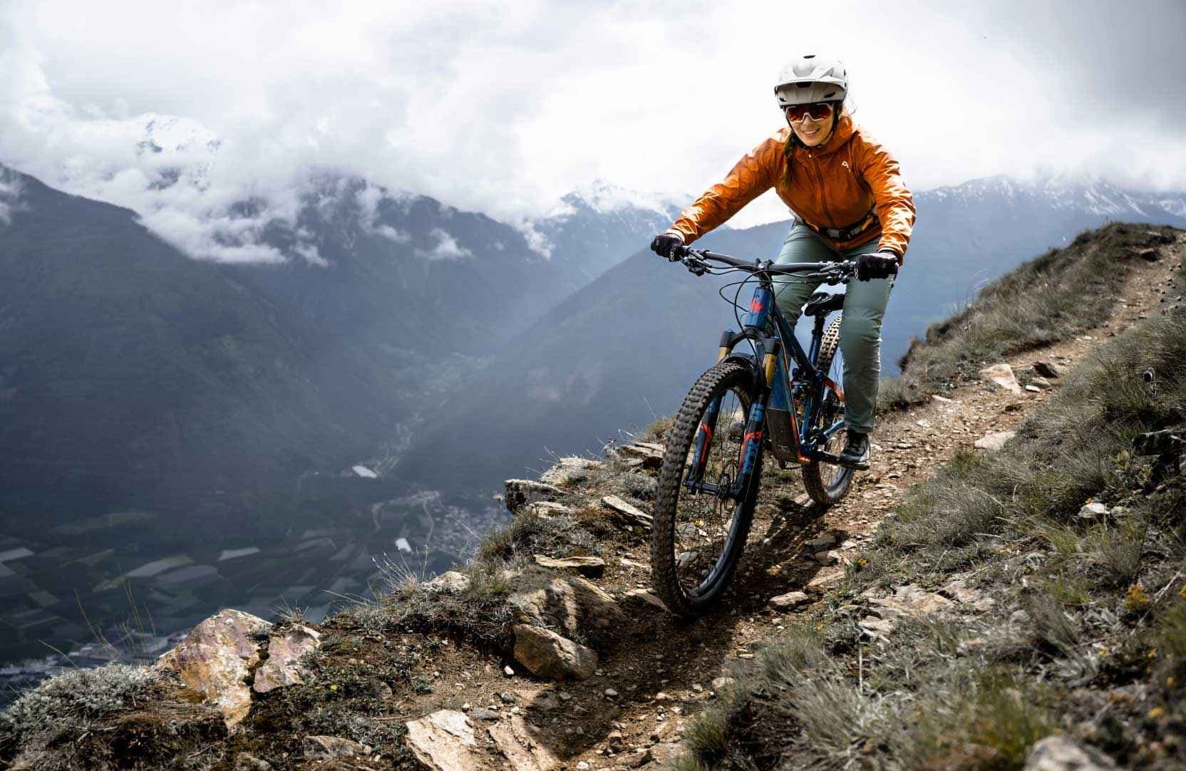 Rider on a Fazua-powered e-mountain bike descending a rocky alpine trail