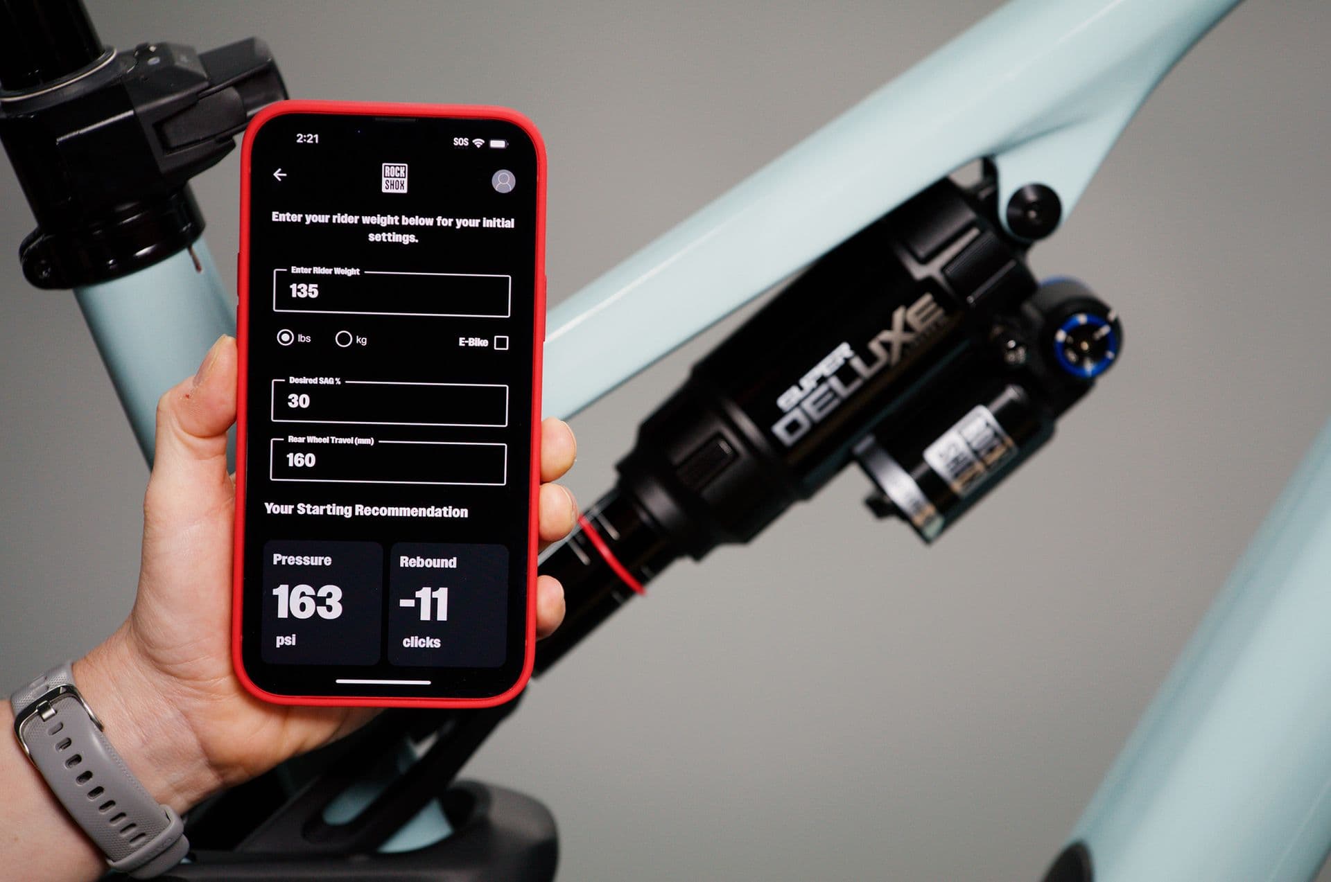 RockShox TrailHead app showing starting air pressure and rebound next to a Super Deluxe rear shock