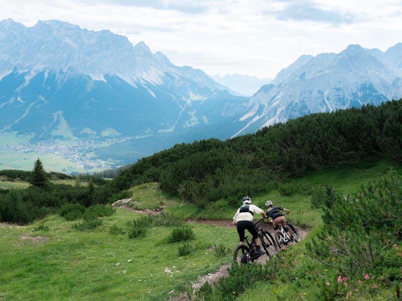 Two riders on an alpine singletrail aboard Propain Sresh SL e-MTBs with TQ HPR60 motors