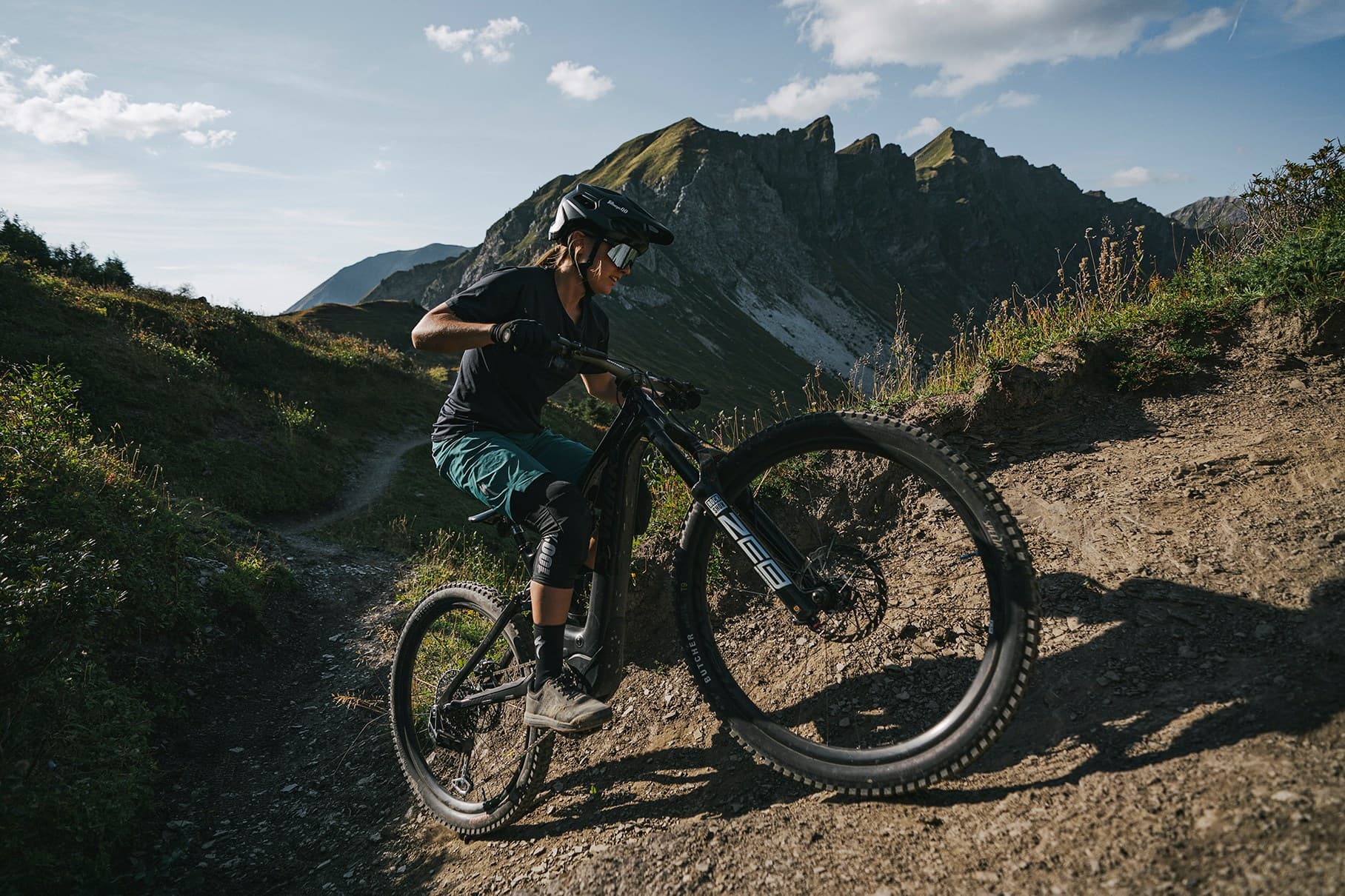 Rider climbing a rocky alpine trail on an e-MTB, SRAM Eagle Transmission campaign photo