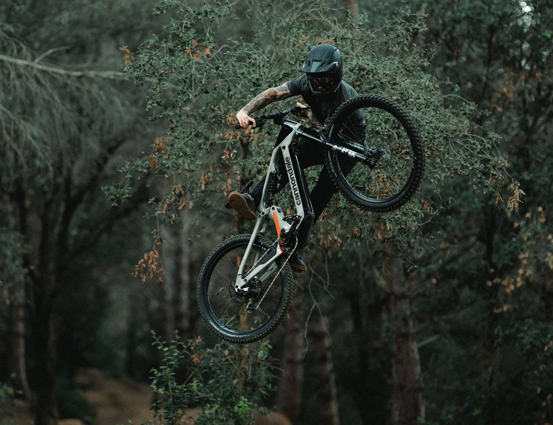 Rider jumping a Cannondale Moterra LT eMTB in the forest
