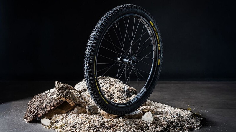 Pirelli Scorpion Black Sting gravity MTB tyre mounted on a wheel, studio shot