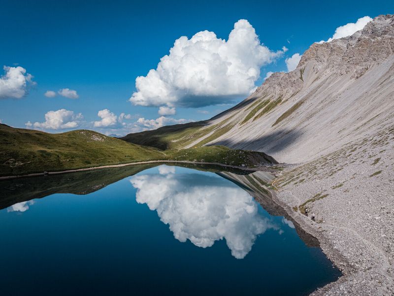 Alpine lake below scree slopes on a Bike Kingdom trail