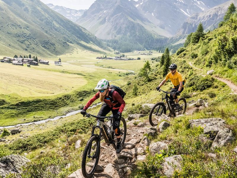 Riders on the Alps Epic Trail singletrack in Davos