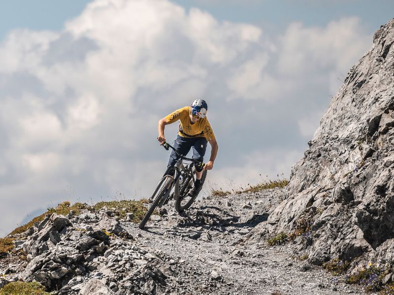 Mountain biker on a rocky alpine trail in Davos Klosters
